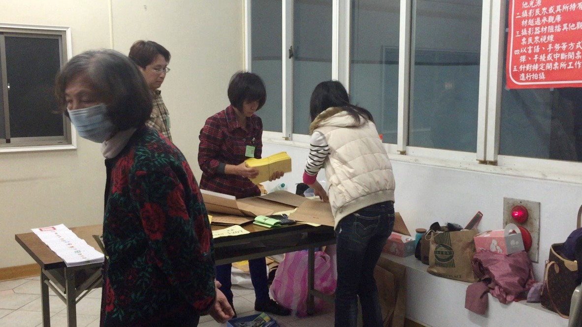Ballot sealing. Yellow ballots are votes for legislators in geographic constituencies.
